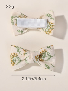 Detail view of handmade embroidered floral bow hair clips showing dimensions and back clip