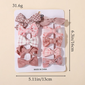 Pink 10-piece hair clip set with bows and patterns on a card for girls