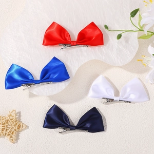 Set of four satin ribbon bow hair clips in vibrant colors with silver metal duckbill clips