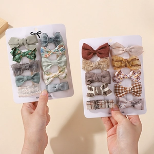 Detail of 20pcs cute fabric hair clips set featuring plaid and floral bows for girls
