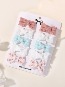 Detail view of 10-piece embroidered bow hair clips set on a display card
