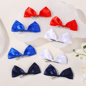 Set of eight satin bow hair clips in vibrant red, royal blue, white, and navy blue for girls