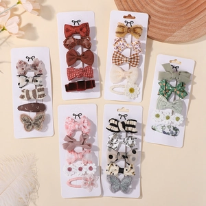Close-up of cute children's hair clip sets with diverse bow and floral patterns