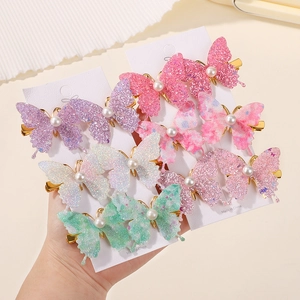 Detail of glitter butterfly hair clips with pearl accents on display cards