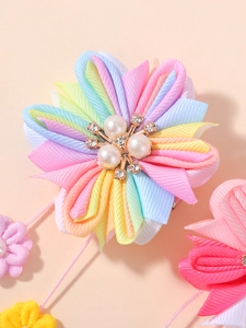 Détail d'une pince à cheveux fleur arc-en-ciel avec perles et strass brillants