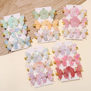 Glitter butterfly hair clips with pearl detail and colorful sequins on gold alligator clips