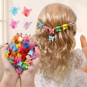 Detailed view of colorful mini butterfly hair clips on golden blonde hair curls