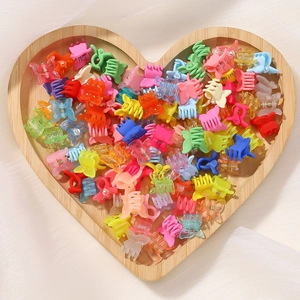 Mini colorful butterfly hair claws and clips set displayed in a heart-shaped wooden tray