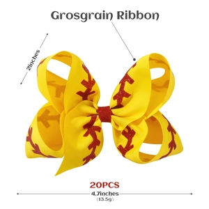 Detail view of 4.7-inch yellow grosgrain ribbon hair bow with red glitter baseball stitching