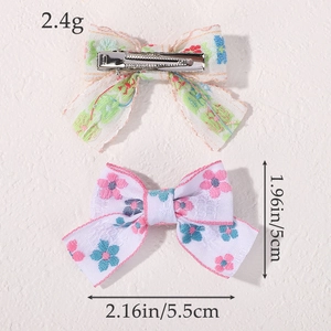 Pink floral and green patterned fabric bow hair clips set with metal alligator clips