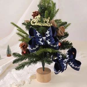Set of two navy blue ribbed bows with white snowflake prints on a Christmas tree