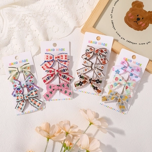 Chic bow hair clip set with floral and heart patterns on handmade display cards