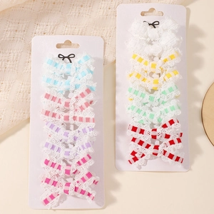 Detailed set of 10 pairs of lace embroidered bow hair clips in various pastel colors