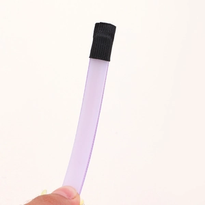 Close-up of lilac satin ribbon finish with black textured fabric end on kids headband