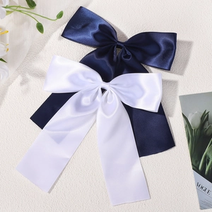 Elegant satin bow hair clips set in navy blue and white with long flowing streamers