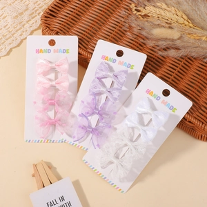 Detailed macro view of lace bow hair clips set for girls on handmade display cards