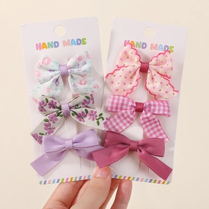 Détails du lot de barrettes à nœuds faites main aux motifs floraux et à pois variés
