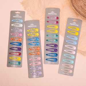 Detail of colorful daisy flower hair clips set in pastel shades on display cards