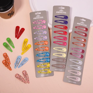 Detail showing various colorful floral and glitter BB hair clips on display cards
