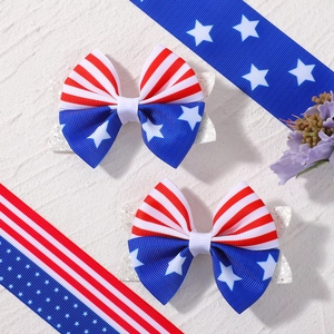 Detail of American flag hair bows with glitter backing on marble background