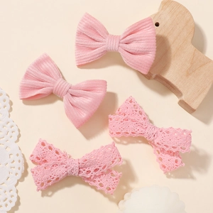 Cute set of four pink bow hair clips with corduroy and lace patterns for girls
