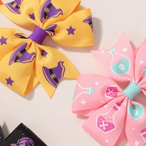 Close-up of Halloween hair bows with witch hat and magic potion bottle patterns