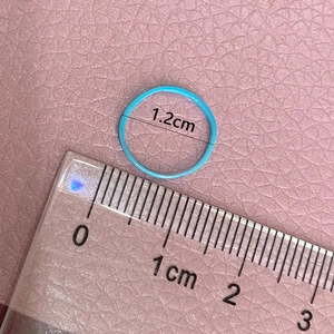 Elastic light blue hair band with 1.2cm diameter shown on a measuring scale