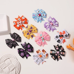 Detailed view of 10 Halloween hair bows with pumpkins, ghosts, and spider web patterns