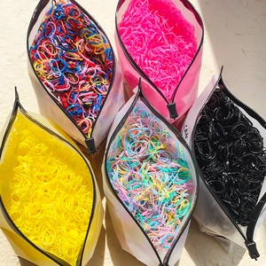 Five translucent frosted pouches filled with multi-colored elastic hair ties for women