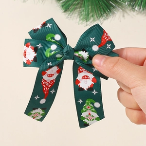 Detail of Christmas gnome ribbon hair bow in dark green with snowflake patterns