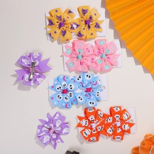 Detailed view of Halloween hair clips set featuring assorted bows with spooky festive patterns