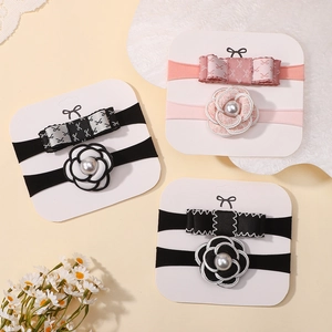 Detail of baby nylon headbands with fabric flowers, bows, and faux pearls on display cards