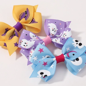 Detailed view of Halloween hair clips featuring wizard hat, ghost, and skull patterns
