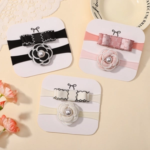 Three-pack of elastic baby nylon headbands with camellia flowers and bow details