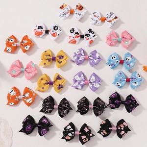 Close-up of Halloween hair clip set featuring festive ghost and pumpkin patterns