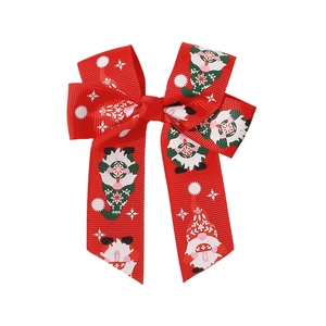 Christmas hair bow with red grosgrain ribbon featuring gnome and snowflake patterns