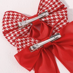 Detail of the durable silver metal alligator clips on red and houndstooth hair bows