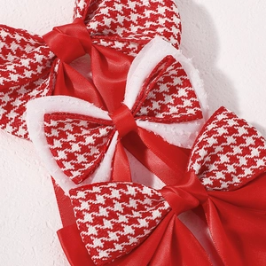 Detail of red houndstooth bow hair clip with satin ribbon and lace layering