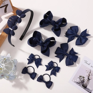 Detail of navy blue ribbon bow hair accessory set with pearls and matching headbands