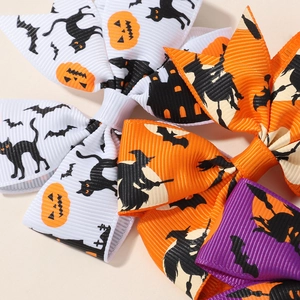 Close-up of Halloween hair bows made of grosgrain ribbon with black cat and bat patterns