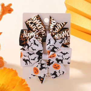 Detail of Halloween bow hair clips with Happy Halloween text and festive patterns
