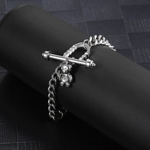 Detailed macro view of silver cuban chain with rhinestone bear pendant and toggle clasp