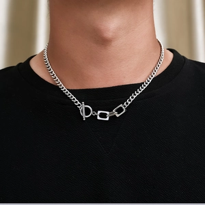 Detailed view of silver stainless steel Cuban chain with OT buckle and square links