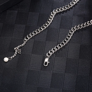 Close-up of hip-hop silver chain with secure lobster clasp and elegant pearl detail