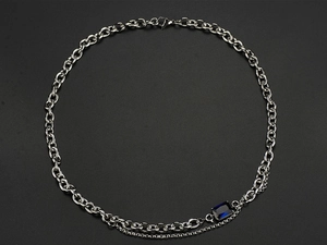 Detailed close-up of double-layer titanium steel necklace with blue sapphire pendant