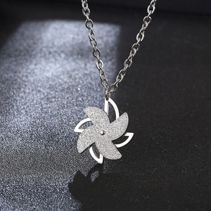 Rotating windmill pendant necklace in matte stainless steel with silver crossbody chain