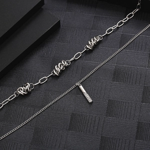 Double-layered silver titanium steel necklace featuring thorn knots and a diamond-paved tube pendant