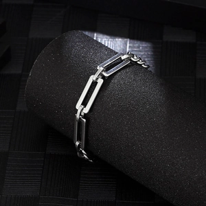 Detailed macro view of square link titanium steel bracelet with polished metallic finish