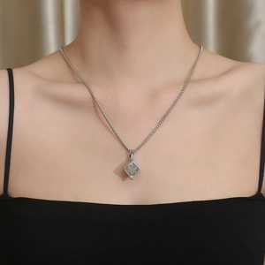 Close-up of hip-hop glow-in-the-dark tree of life necklace on a model's neck