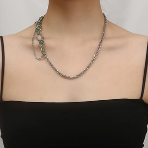 Detail of titanium steel asymmetrical necklace with green floral beads and silver chain